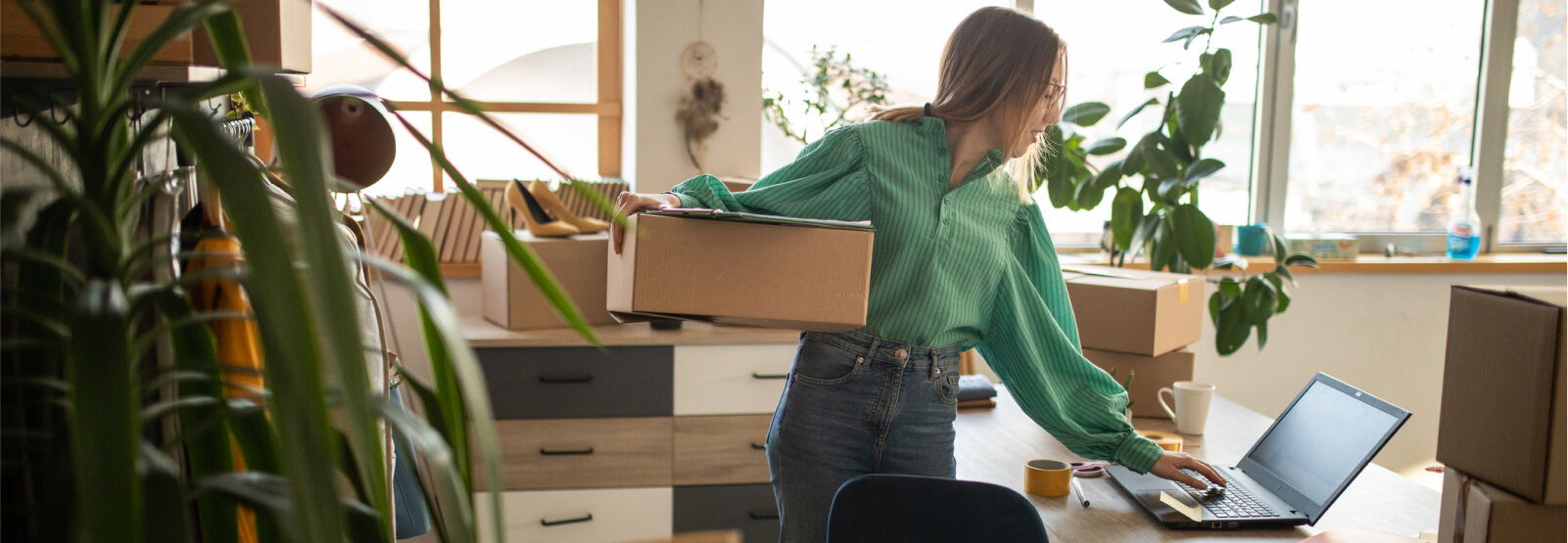 Business woman holding a large shipping box