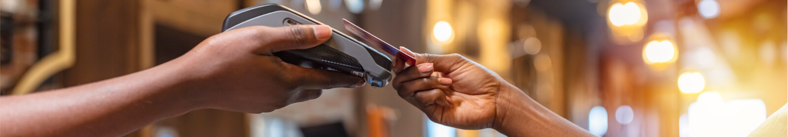 Close up of a person's hands using a card reader