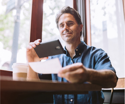 Man taking a picture of a check with a smartphone